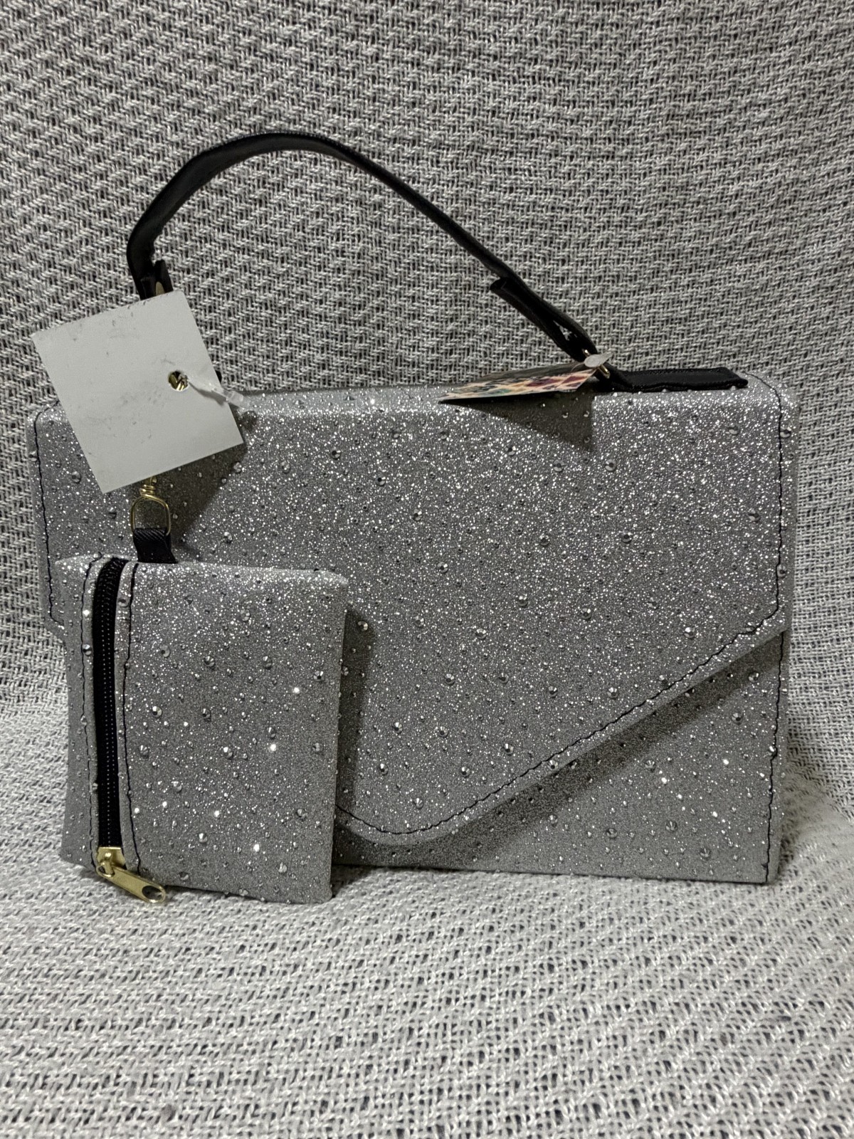 Medium sized, silver and studded handbag with crossbody strap and coin purse