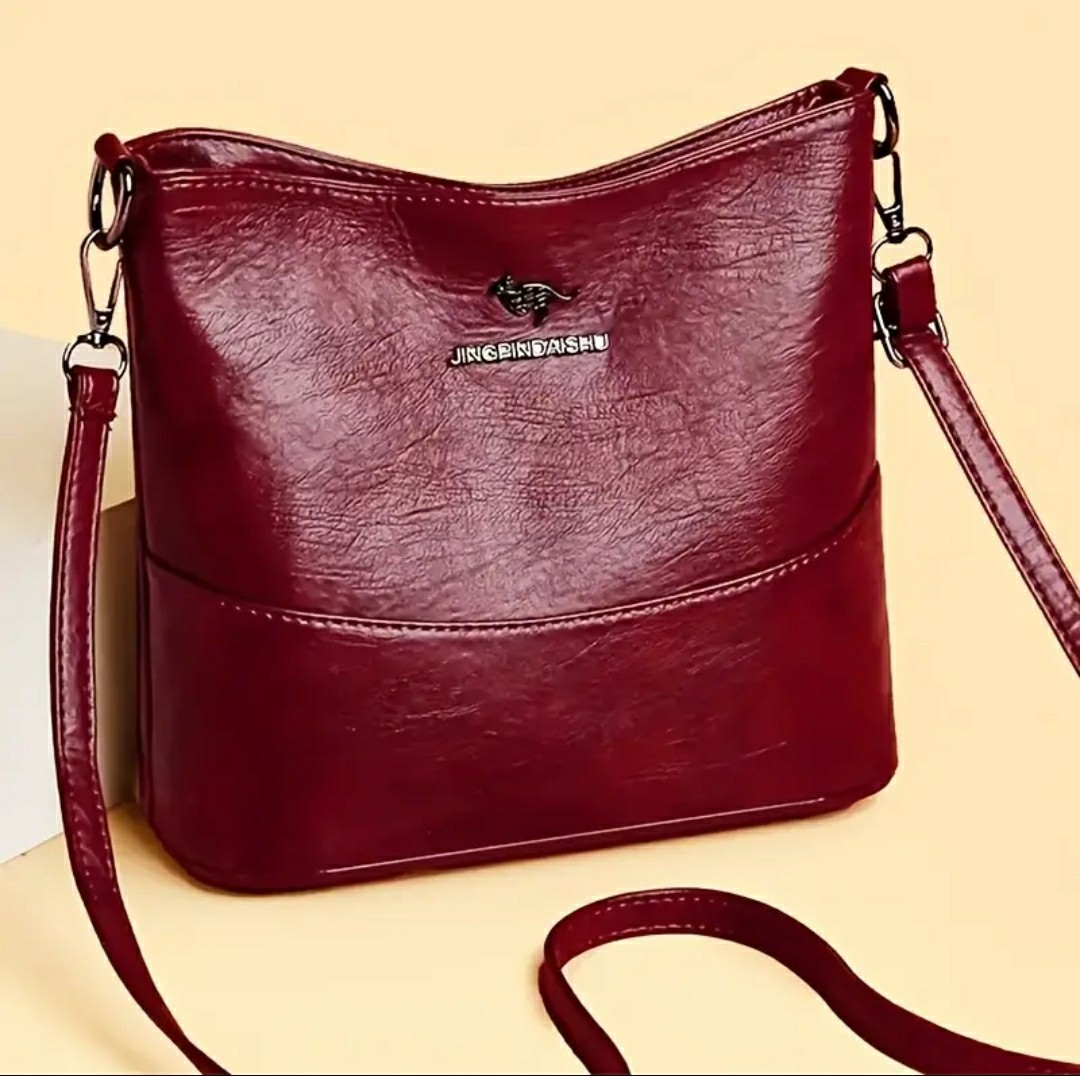 Adjustable Crossbody Bag, Zipper Closure, Stylish City Accessory.