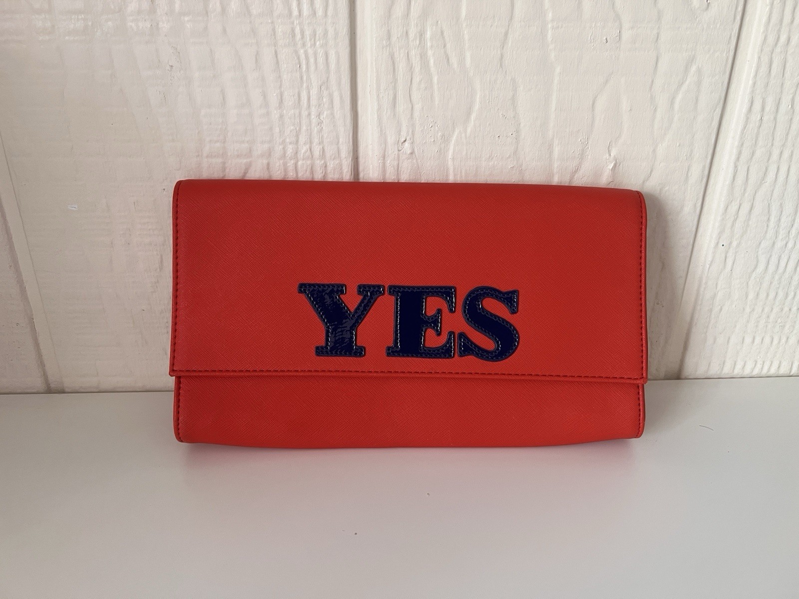Jonathan Alder red YES clutch purse