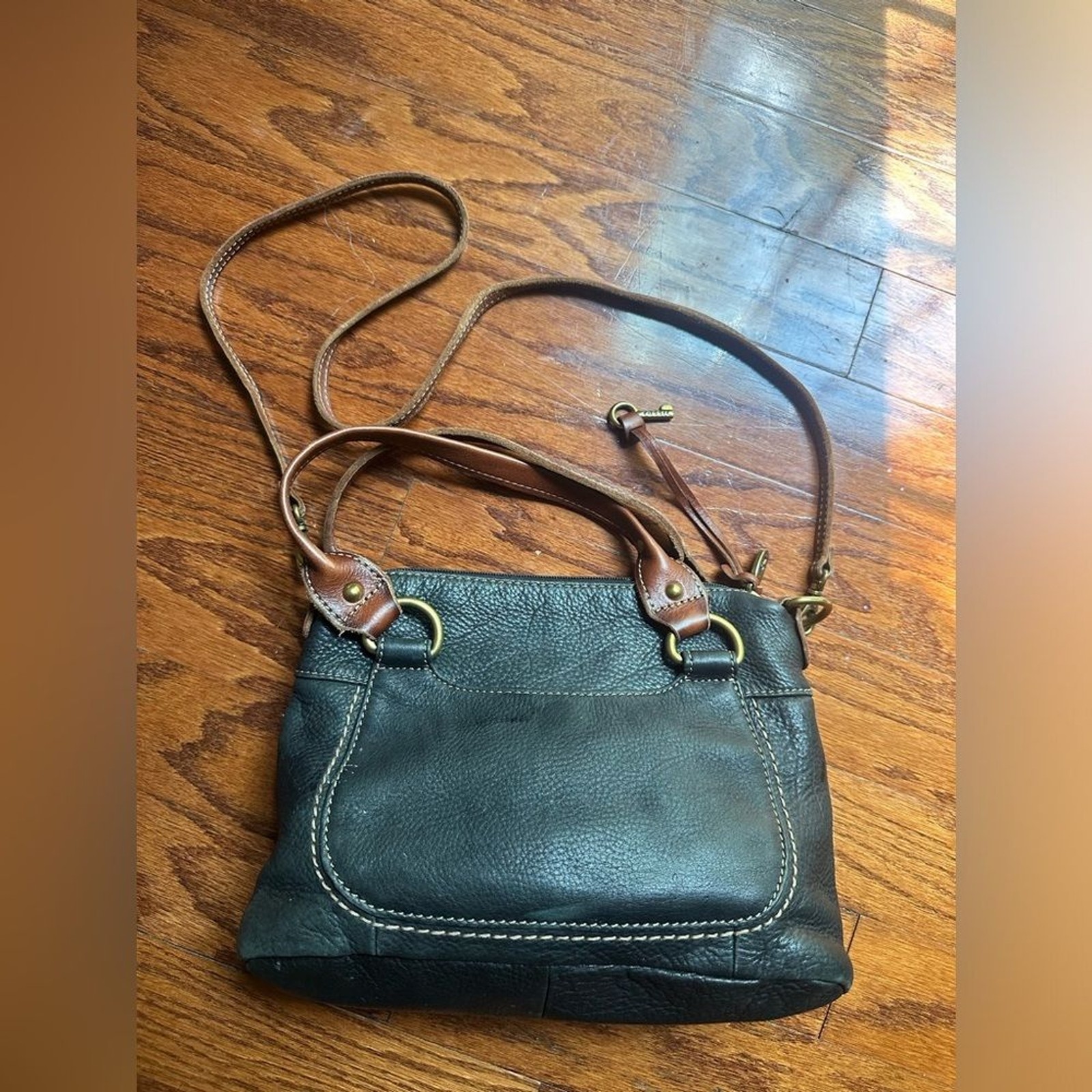 Fossil purse is black pebbled leather & brown leather straps & brass hardware