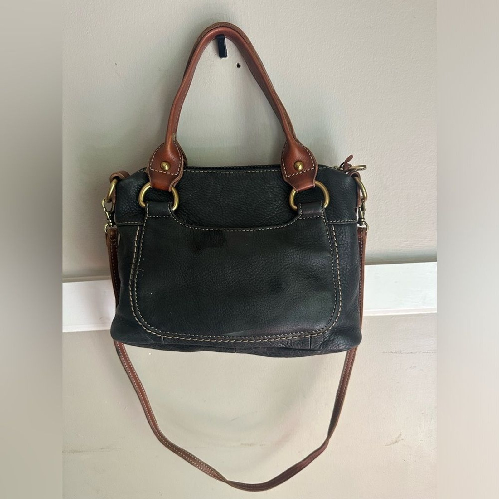 Fossil purse is black pebbled leather & brown leather straps & brass hardware