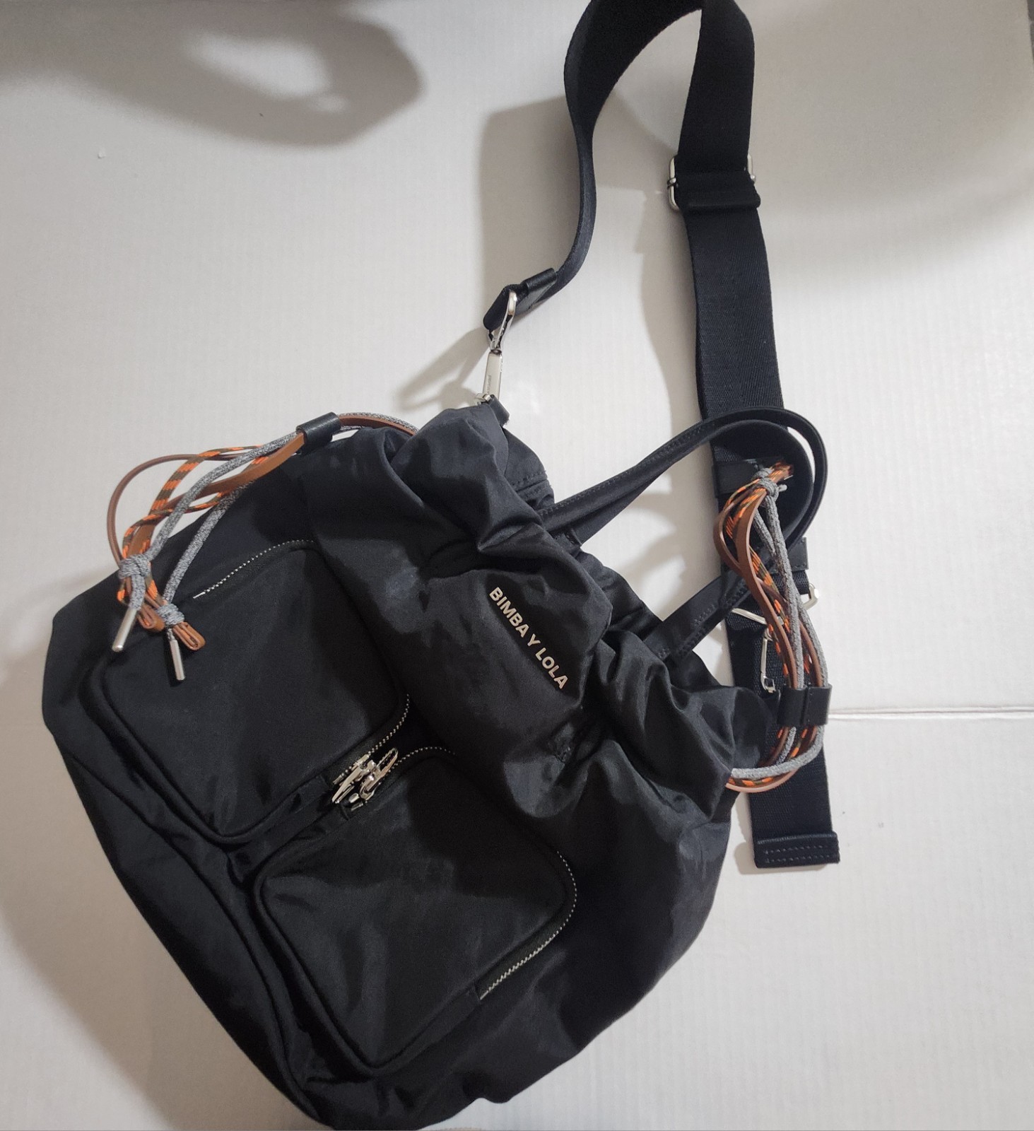 BIMBA Y LOLA Black Drawstring Bag Silver Hardware Logo Front Zip Pockets Strap