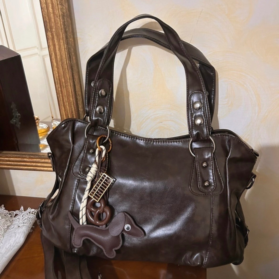 brown shoulder bag with charm