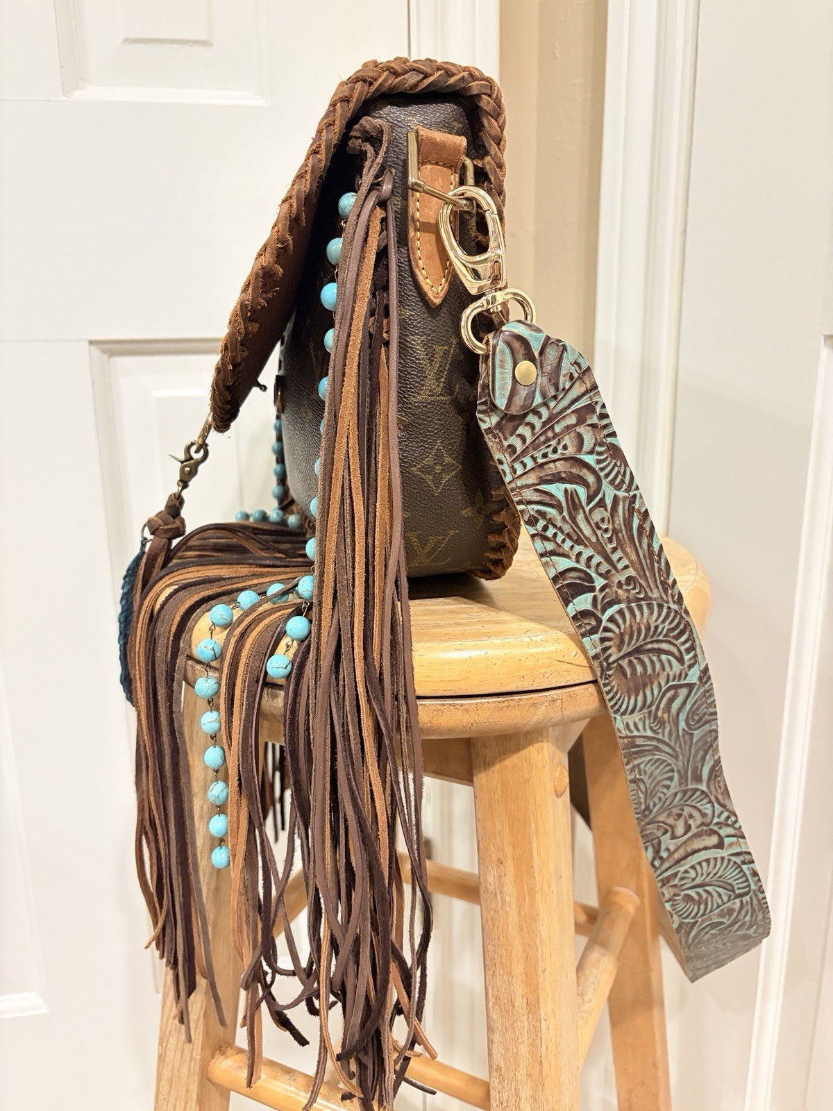 Louis Vuitton St. Cloud GM intricate brown braided leather trim and long fringe