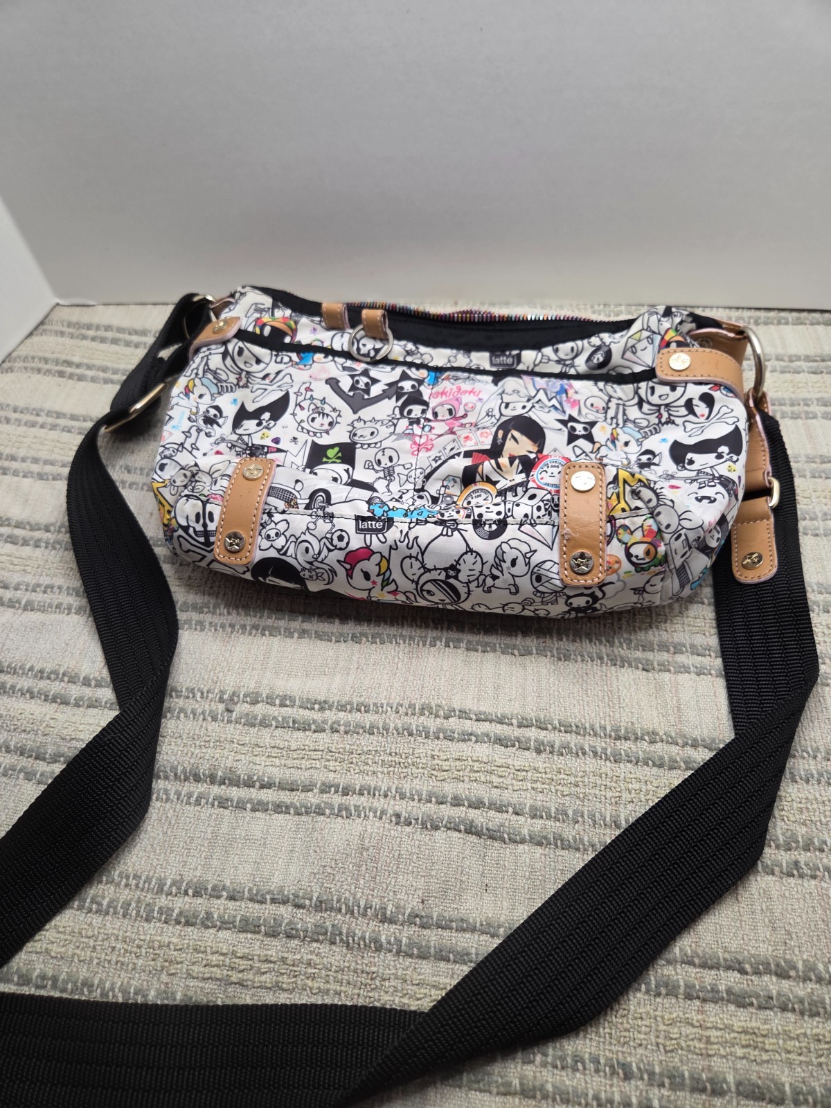 tokidoki shoulder bag with all over skulls and various figures