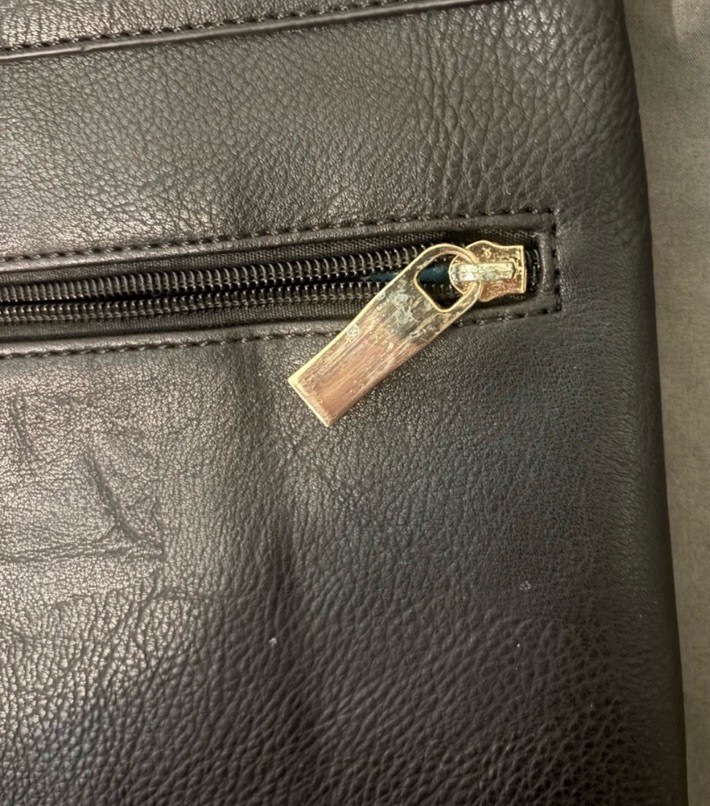 Black Studded Leather Clutch with Gold Grommets said to be a 1990s fossil bag