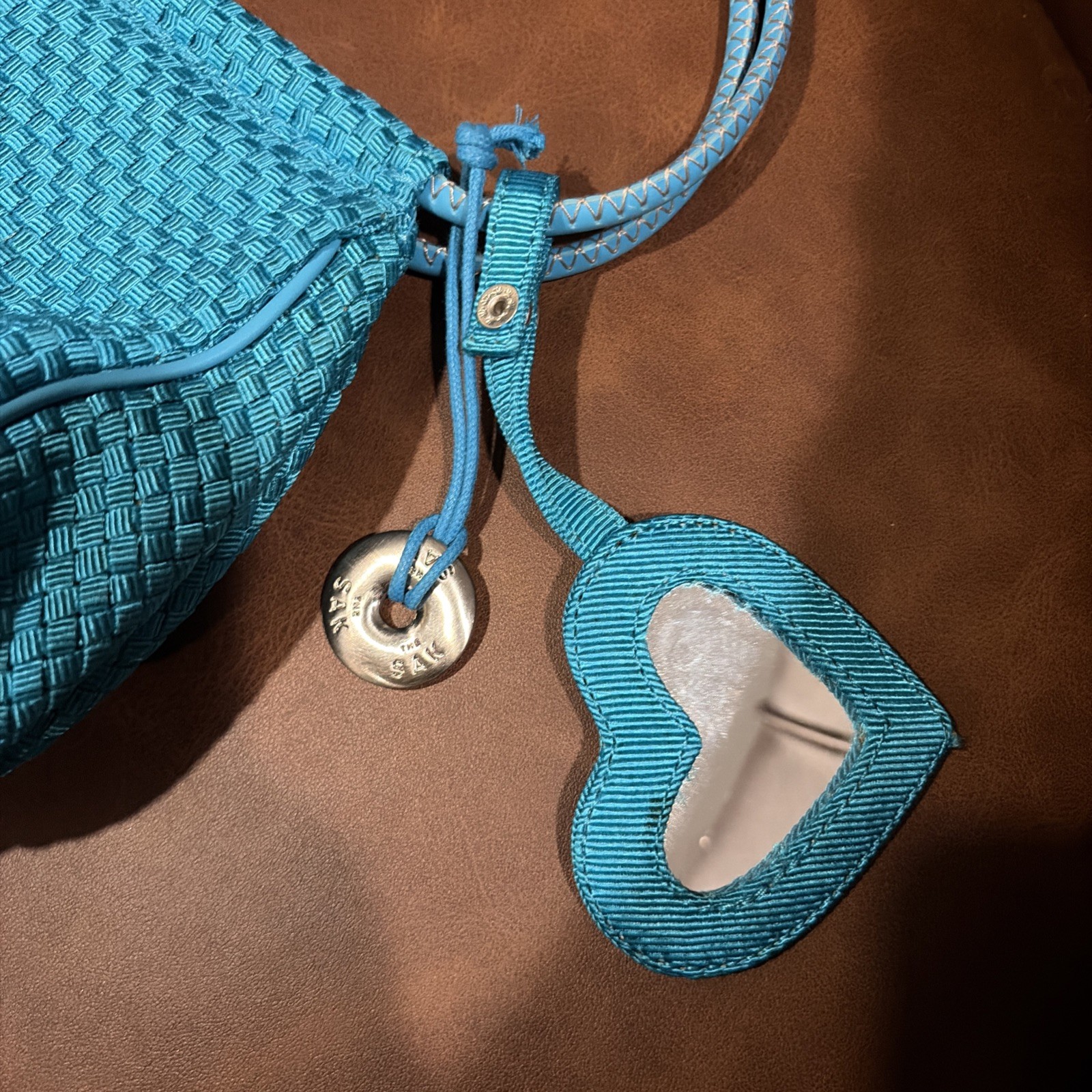 The Sak Mini Shoulder Bag woven w vegan leather trim turquoise heart