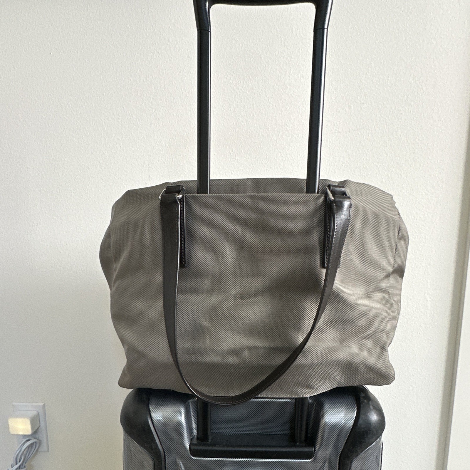 TUMI Beige Tote Bag Zip Top Black Leather Shoulder Straps Luggage Tag Pockets
