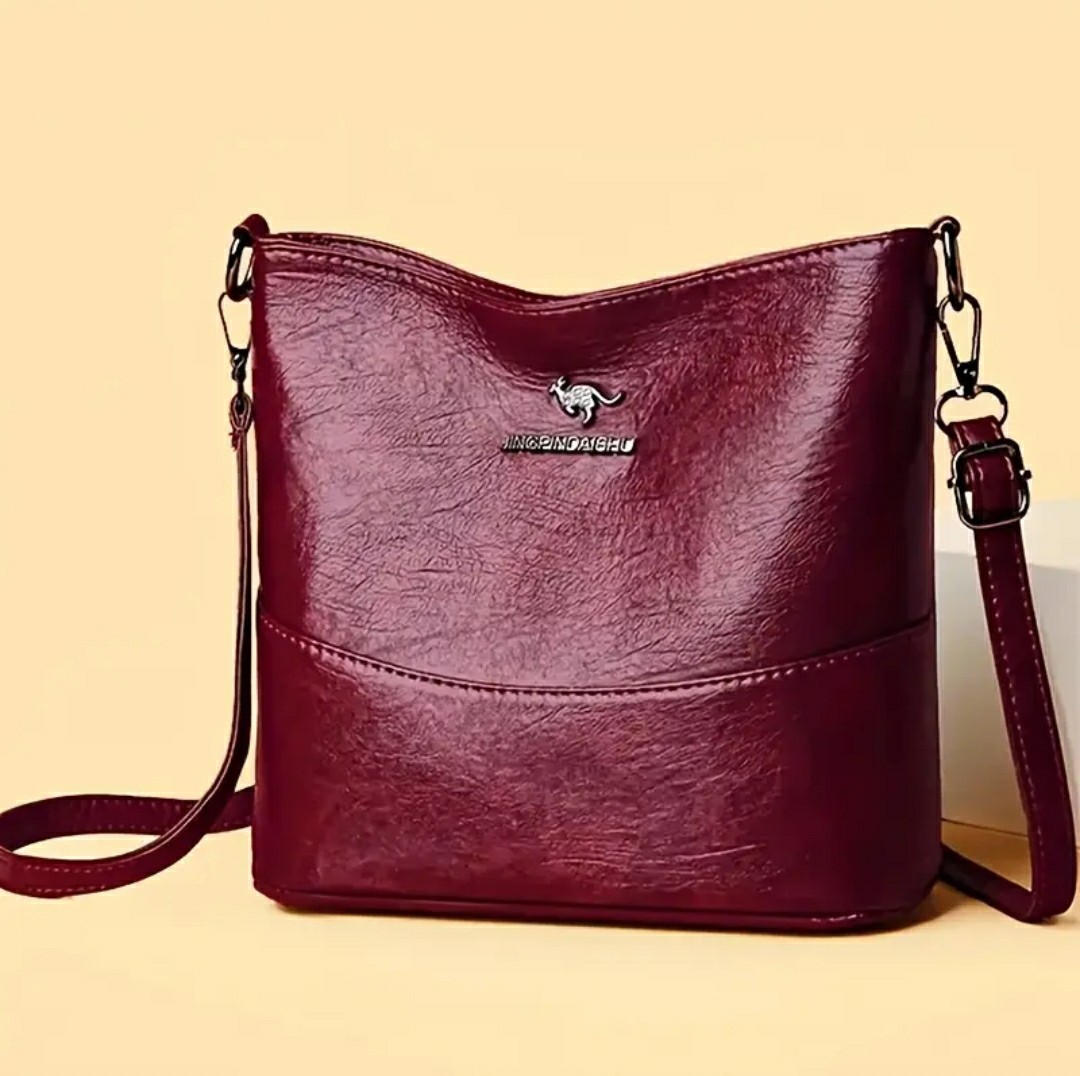 Adjustable Crossbody Bag, Zipper Closure, Stylish City Accessory.
