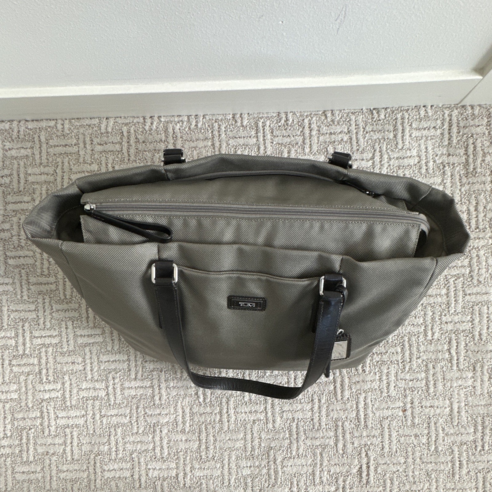 TUMI Beige Tote Bag Zip Top Black Leather Shoulder Straps Luggage Tag Pockets