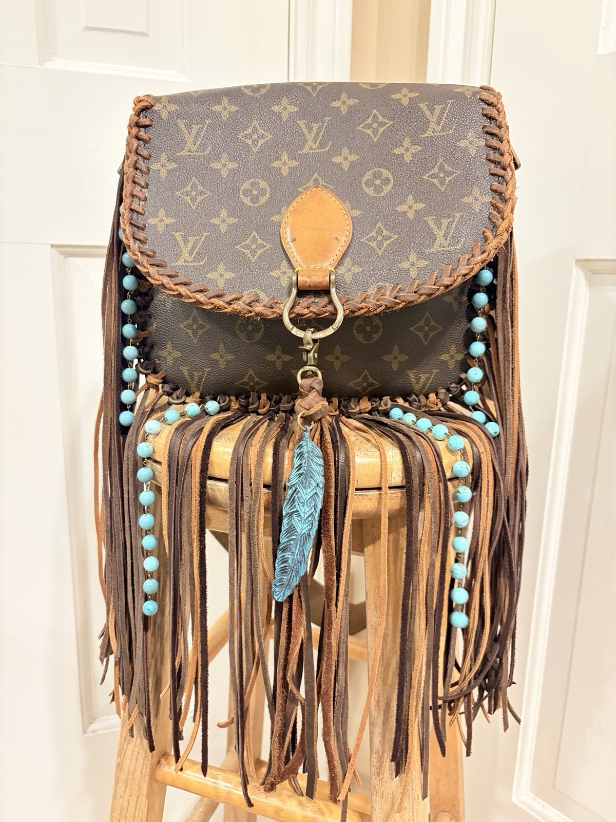 Louis Vuitton St. Cloud GM intricate brown braided leather trim and long fringe